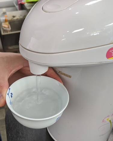 Pouring hot water into a teacup