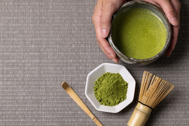 Matcha powder, bamboo whisk and prepared matcha